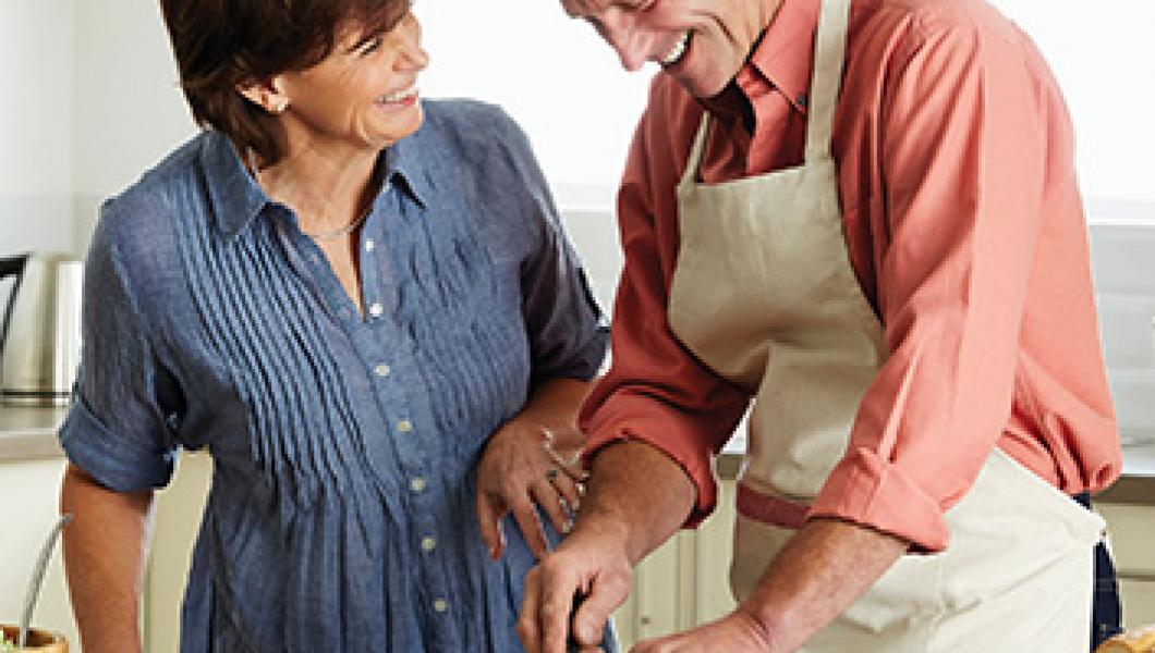 mature couple chopping vegetables