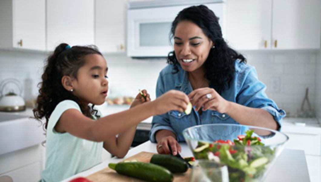 mother and daughter in kitchen with vegetables