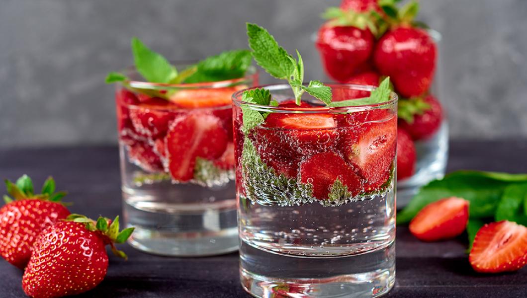 Glasses of water with strawberries