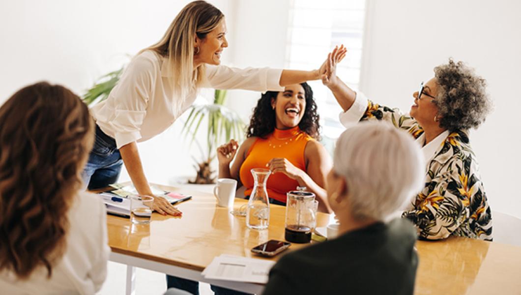 coworkers high fiving in meeting