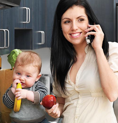 mother on phone next to infant