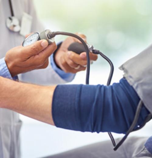 doctor testing blood pressure of patient