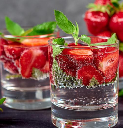 Glasses of water with strawberries