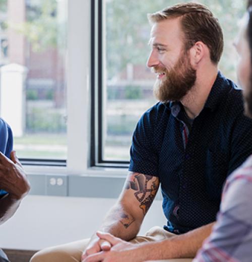 Three men talking at meeting