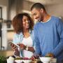 couple cooking and looking at tablet