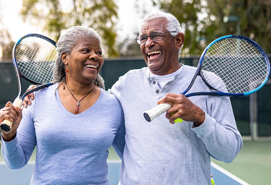 Active older couple at the tennis court